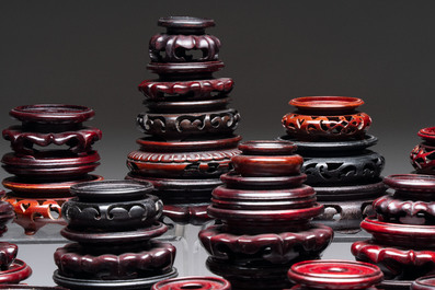 A collection of 80 Chinese wooden stands, 19/20th C.