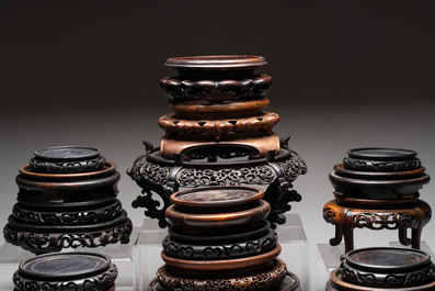 A collection of 25 Chinese wooden stands, 19/20th C.