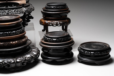 A collection of 25 Chinese wooden stands, 19/20th C.