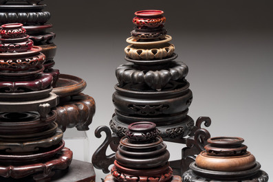 A collection of 70 Chinese wooden stands and covers, 19/20th C.