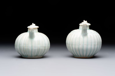 A pair of Chinese qingbai ewers and covers with dragon-form handles, Song/Yuan