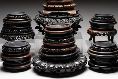 A collection of 25 Chinese wooden stands, 19/20th C.