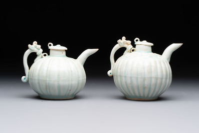 A pair of Chinese qingbai ewers and covers with dragon-form handles, Song/Yuan