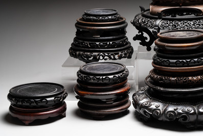 A collection of 25 Chinese wooden stands, 19/20th C.
