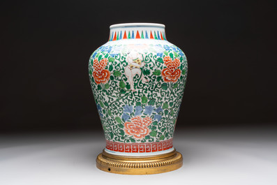 A Chinese wucai 'He He Er Xian' vase on gilt-bronze stand, 19th C.