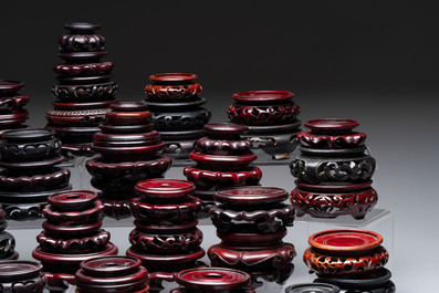 A collection of 80 Chinese wooden stands, 19/20th C.