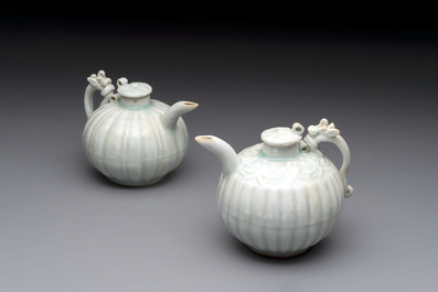 A pair of Chinese qingbai ewers and covers with dragon-form handles, Song/Yuan