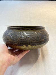 A Persian silver- and copper-inlaid 'calligraphic' brass bowl, 18th C.
