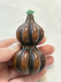 A Chinese blue and white double-gourd snuff bottle and a huali snuff bottle, Xuande and Qianlong mark, 18th C.