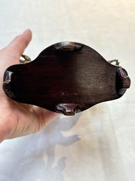 A Sino-Tibetan gilt-bronze figure of White Mahakala on wooden stand, 18th C.