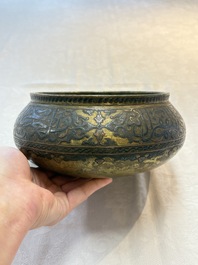 A Persian silver- and copper-inlaid 'calligraphic' brass bowl, 18th C.