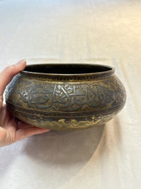 A Persian silver- and copper-inlaid 'calligraphic' brass bowl, 18th C.