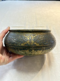A Persian silver- and copper-inlaid 'calligraphic' brass bowl, 18th C.