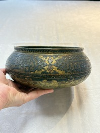 A Persian silver- and copper-inlaid 'calligraphic' brass bowl, 18th C.