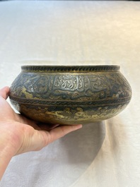 A Persian silver- and copper-inlaid 'calligraphic' brass bowl, 18th C.