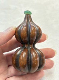 A Chinese blue and white double-gourd snuff bottle and a huali snuff bottle, Xuande and Qianlong mark, 18th C.