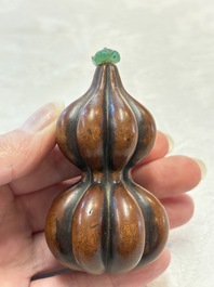 A Chinese blue and white double-gourd snuff bottle and a huali snuff bottle, Xuande and Qianlong mark, 18th C.