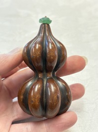 A Chinese blue and white double-gourd snuff bottle and a huali snuff bottle, Xuande and Qianlong mark, 18th C.