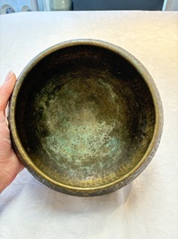 A Persian silver- and copper-inlaid 'calligraphic' brass bowl, 18th C.