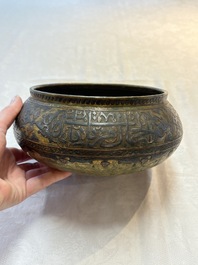 A Persian silver- and copper-inlaid 'calligraphic' brass bowl, 18th C.