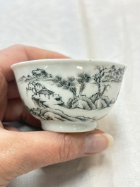 A pair of Chinese grisaille and iron-red 'landscape' cups and saucers, Yongzheng/Qianlong