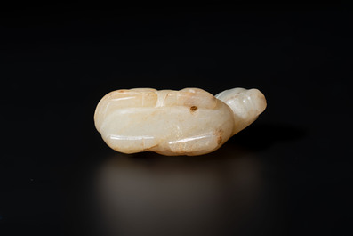 A Chinese white and russet jade pendant in the form of a horse, Song/Ming