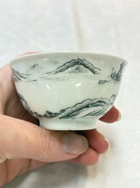 A pair of Chinese grisaille and iron-red 'landscape' cups and saucers, Yongzheng/Qianlong