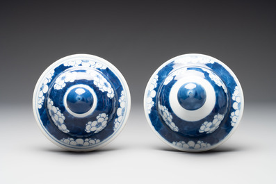 A pair of Chinese blue and white covered vases with floral design, 19th C.