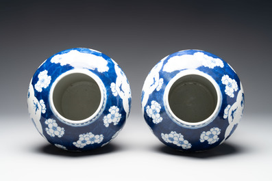 A pair of Chinese blue and white covered vases with floral design, 19th C.