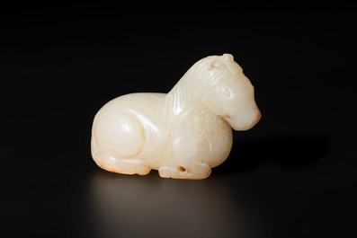 A Chinese white and russet jade pendant in the form of a horse, Song/Ming