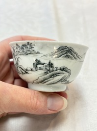 A pair of Chinese grisaille and iron-red 'landscape' cups and saucers, Yongzheng/Qianlong