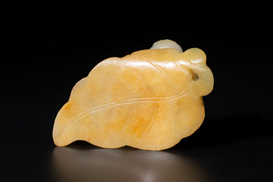 A Chinese white and yellow jade carving of a reclining lady on a leaf, Qing