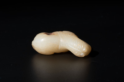 A Chinese white and russet jade pendant in the form of a horse, Song/Ming