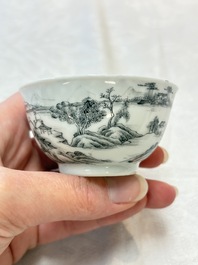 A pair of Chinese grisaille and iron-red 'landscape' cups and saucers, Yongzheng/Qianlong