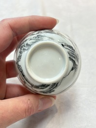 A pair of Chinese grisaille and iron-red 'landscape' cups and saucers, Yongzheng/Qianlong