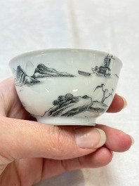 A pair of Chinese grisaille and iron-red 'landscape' cups and saucers, Yongzheng/Qianlong