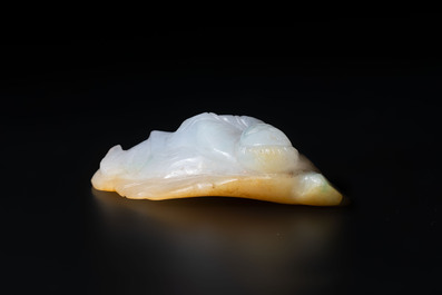 A Chinese white and yellow jade carving of a reclining lady on a leaf, Qing