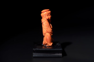 A Japanese red coral sculpture of a fisherman on wooden stand, 19/20th C.