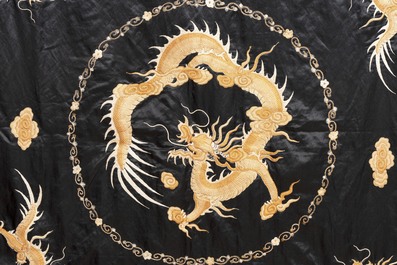 A Chinese black-ground embroidered silk panel with a four-clawed dragon, 19th C.