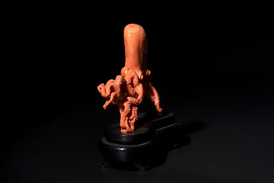 A Japanese red coral sculpture of an octopus on wooden stand, 19/20th C.