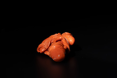 A Japanese red coral sculpture of a fisherman on wooden stand, 19/20th C.