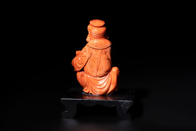 A Japanese red coral sculpture of a fisherman on wooden stand, 19/20th C.