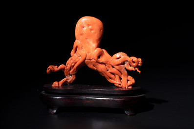 A Japanese red coral sculpture of an octopus on wooden stand, 19/20th C.