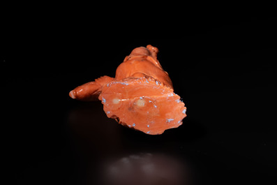 A Japanese red coral sculpture of a fisherman on wooden stand, 19/20th C.