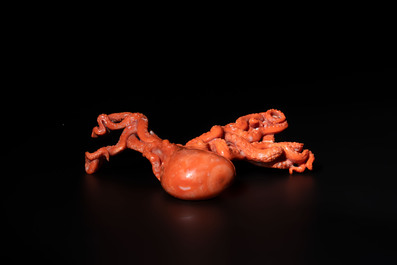 A Japanese red coral sculpture of an octopus on wooden stand, 19/20th C.