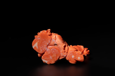 A Chinese red coral sculpture of a Milefo Buddha on wooden stand, 19/20th C.