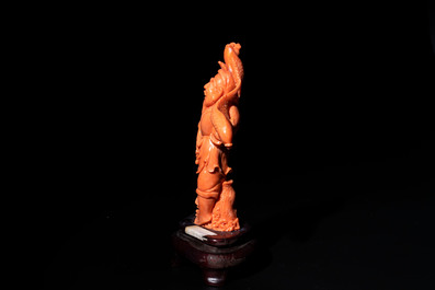 A Japanese red coral sculpture of a fisherman on wooden stand, 19/20th C.