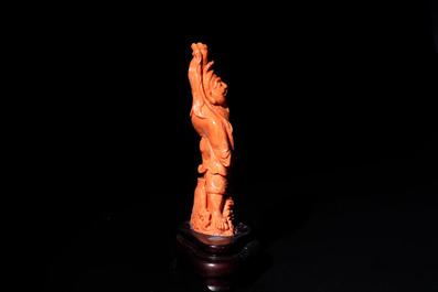 A Japanese red coral sculpture of a fisherman on wooden stand, 19/20th C.