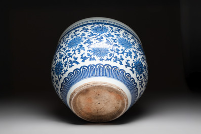 A massive Chinese blue and white 'lotus scroll' fish bowl, Qianlong/Jiaqing