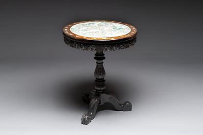 A Chinese mother-of-pearl-inlaid hongmu table with a circular Canton famille verte 'warriors on horseback' plaque, 19th C.